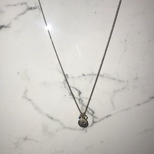 silver sand dollar with blue accent jewels